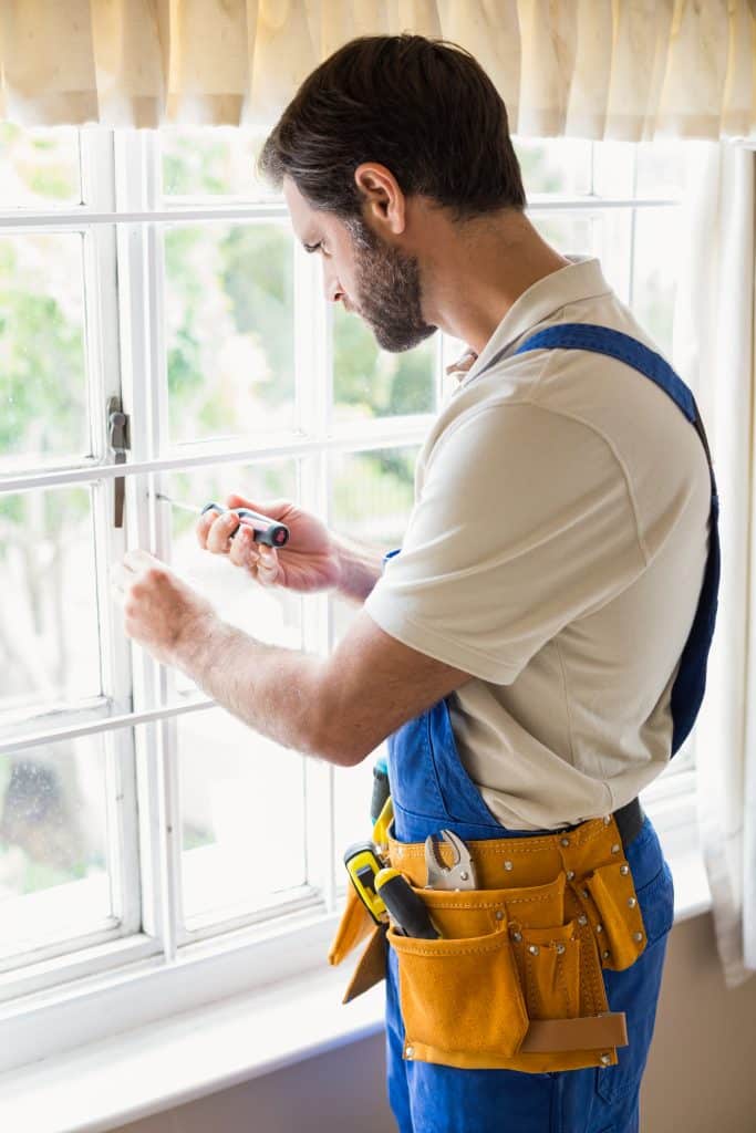 handyman fixing a window in a new house 2023 11 27 05 29 50 utc