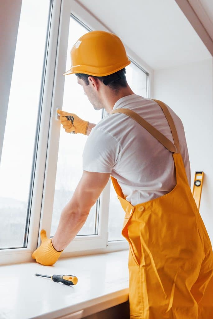 handyman in yellow uniform installs new window ho 2023 11 27 05 23 02 utc