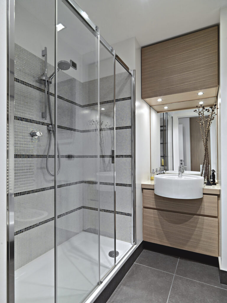 Modern bathroom with glass shower door and vanity mirror