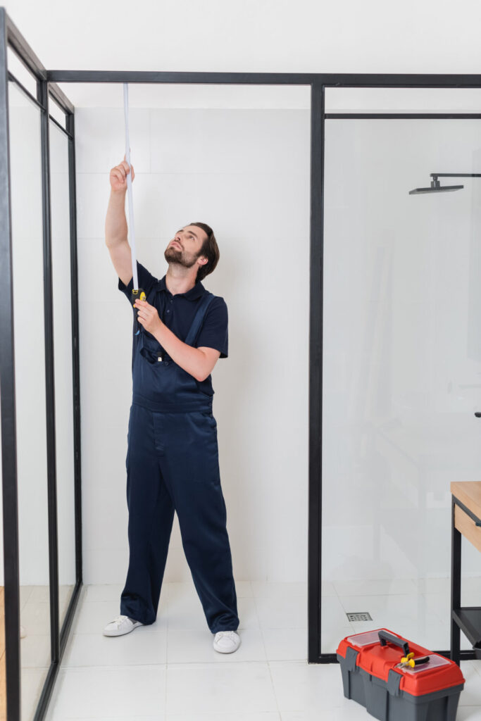 Man measuring shower door