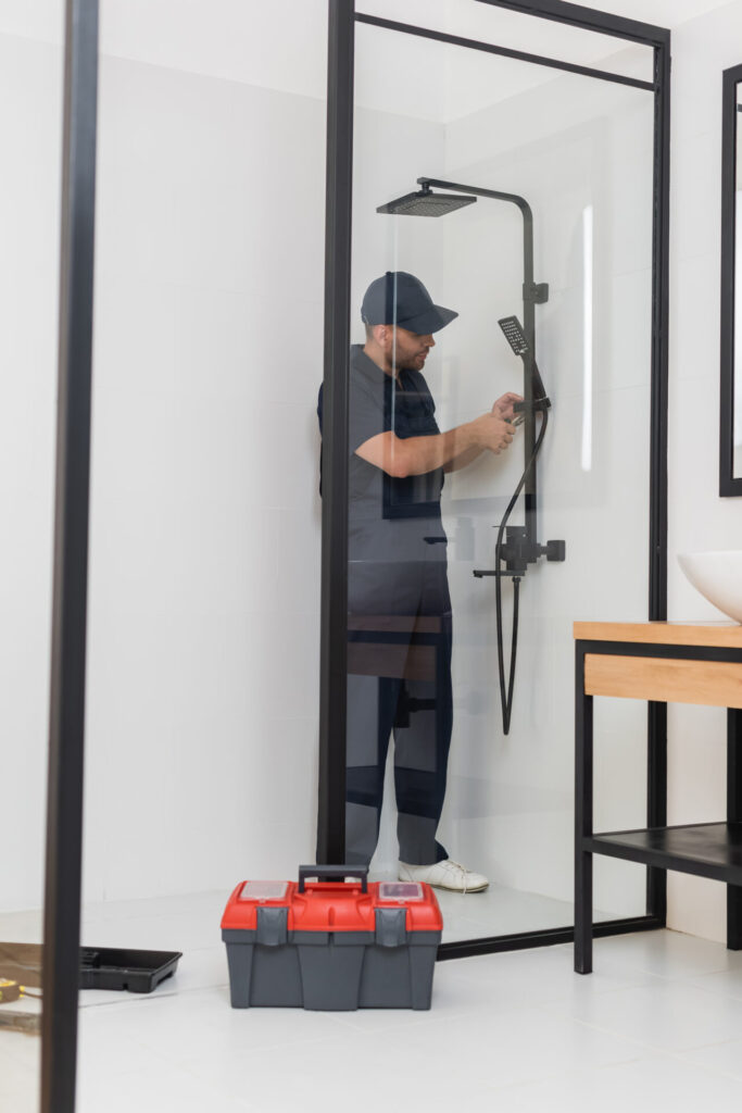 Man Installing new shower door